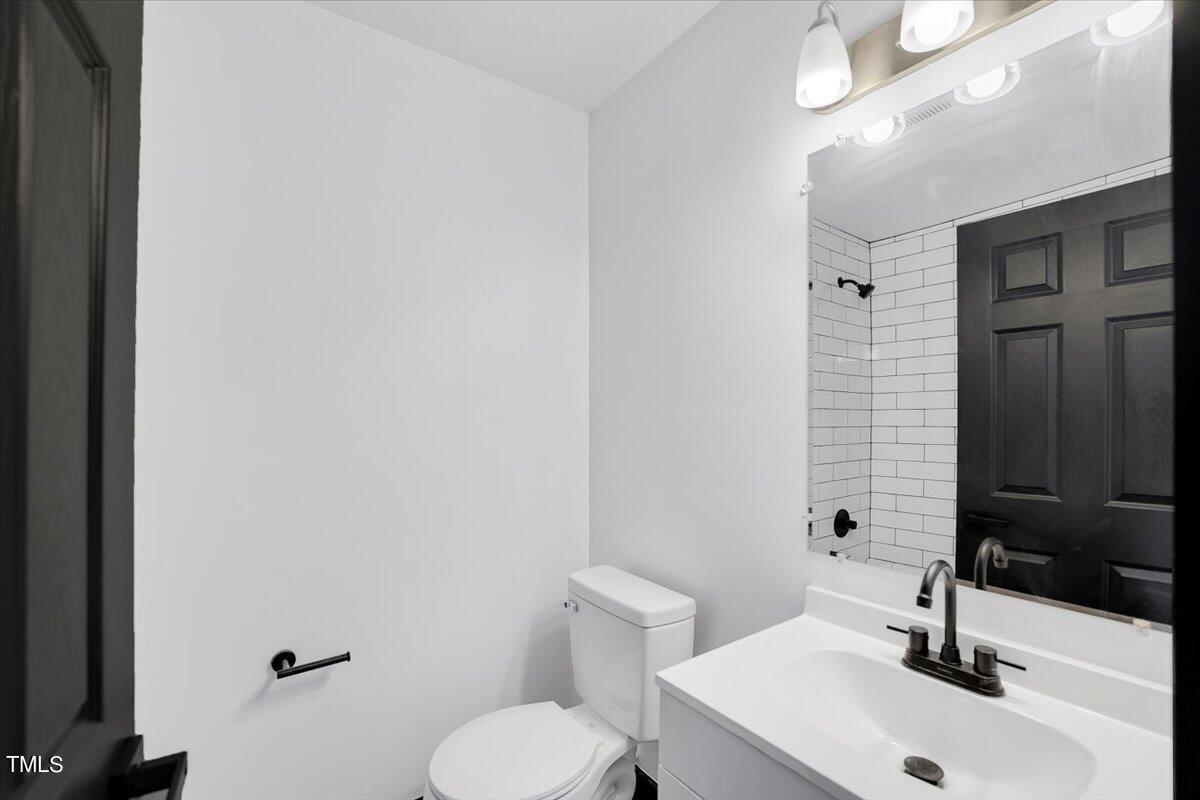 321 East Umstead Street Durham, NC 27707 - Photo 20 of 22 a bathroom with a sink a toilet and mirror