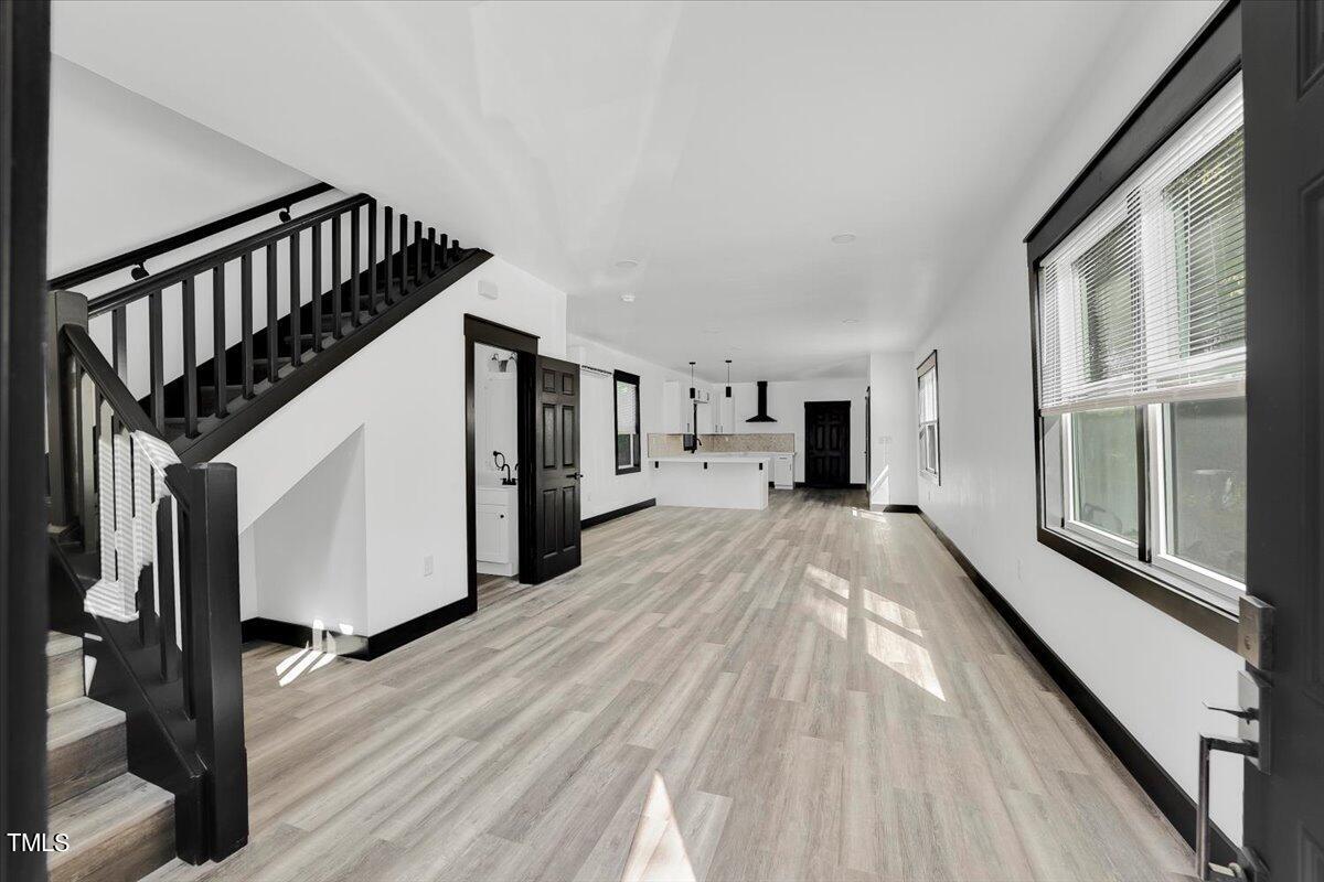 321 East Umstead Street Durham, NC 27707 - Photo 3 of 22 a view of a hallway with wooden floor and staircase