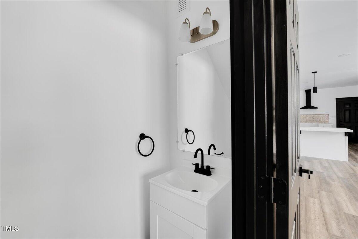 321 East Umstead Street Durham, NC 27707 - Photo 4 of 22 a bathroom with a sink and mirror with shower