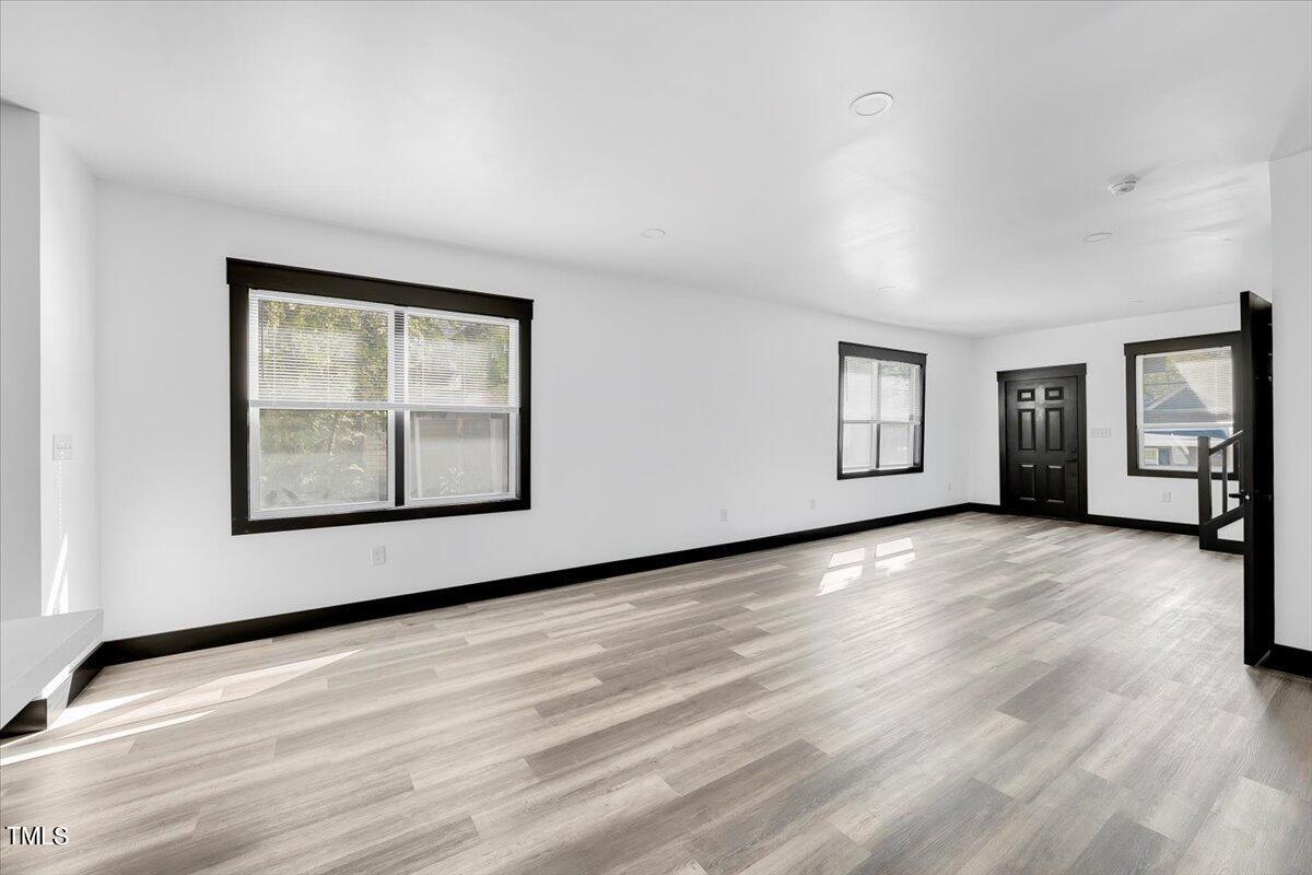 321 East Umstead Street Durham, NC 27707 - Photo 5 of 22 a view of an empty room with a window and wooden floor