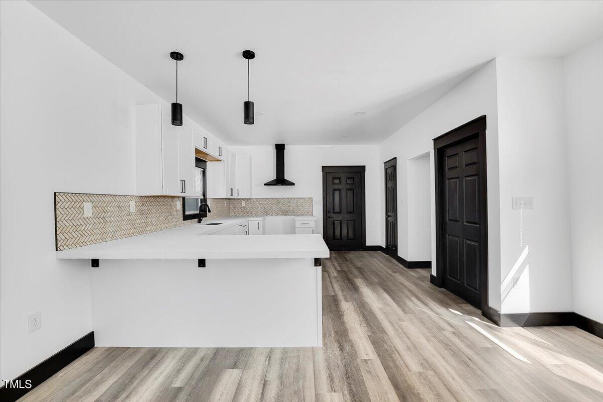 321 East Umstead Street Durham, NC 27707 - Photo 6 of 22 a view of kitchen and hall with wooden floor