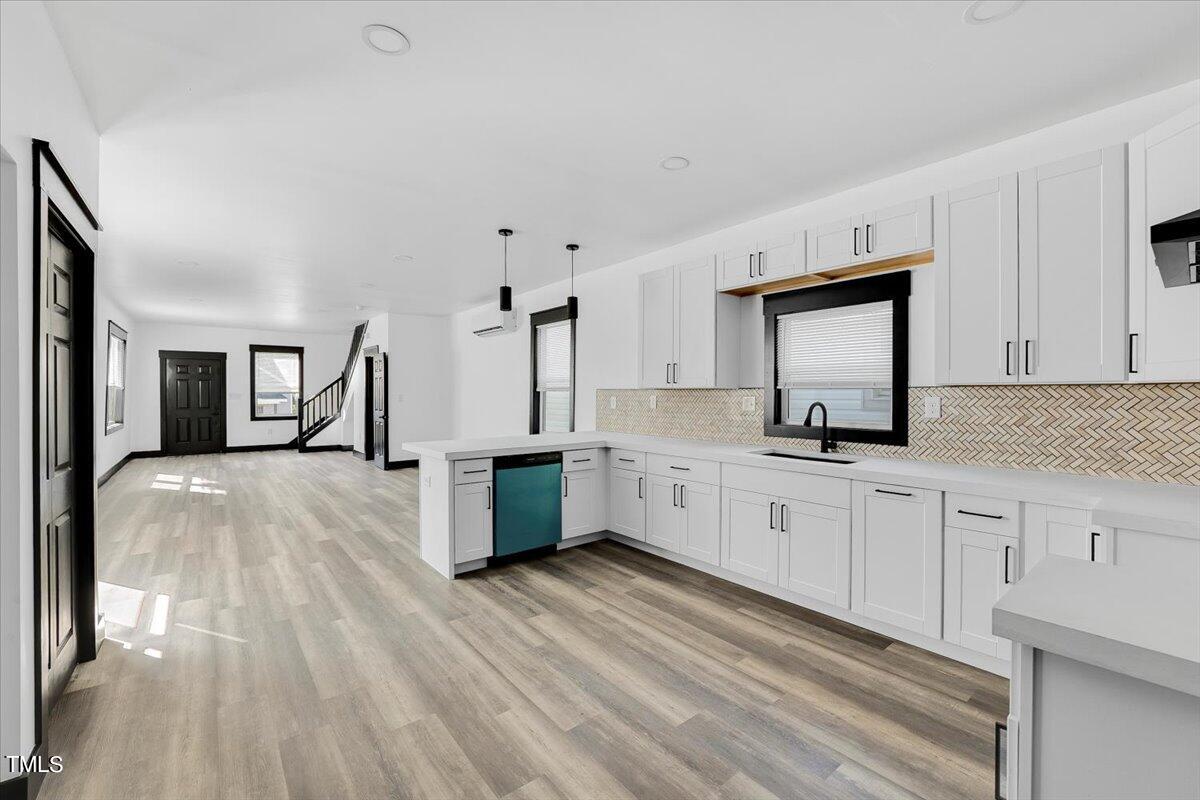 321 East Umstead Street Durham, NC 27707 - Photo 9 of 22 a large white kitchen with sink and white cabinets