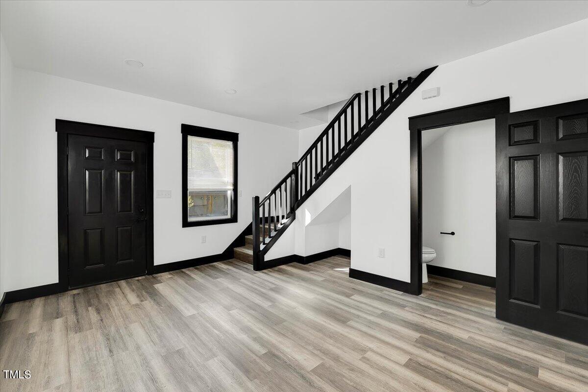 321 East Umstead Street Durham, NC 27707 - Photo 10 of 22 a view of an entryway with wooden floor and door