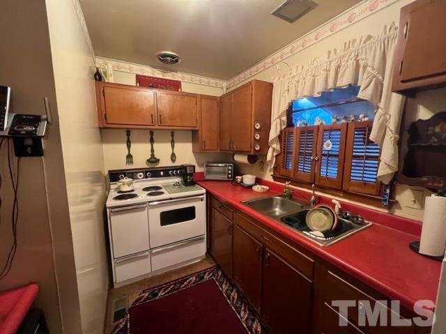 71 Roberts Grove Road Dunn, NC 28334 - Photo 6 of 23 a kitchen with stainless steel appliances a stove a sink and a refrigerator