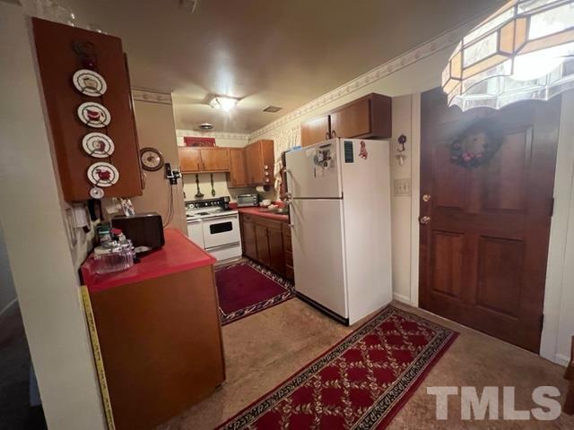 71 Roberts Grove Road Dunn, NC 28334 - Photo 8 of 23 a kitchen with a refrigerator and a stove