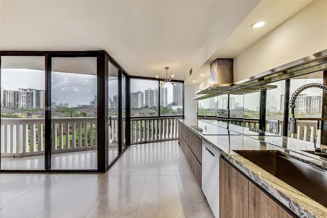 a view of a large kitchen with a large window and sitting area
