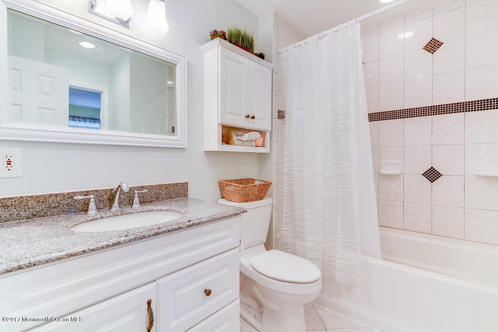 116 Newbury Road Howell, NJ 07731 - Photo 13 of 19 a bathroom with a granite countertop sink a toilet and shower