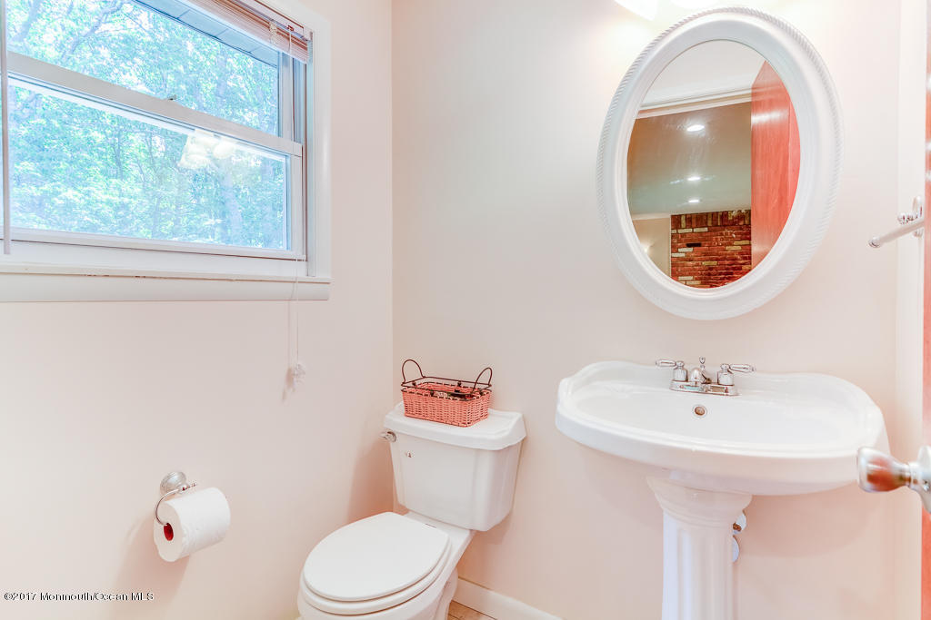 116 Newbury Road Howell, NJ 07731 - Photo 14 of 19 a bathroom with a sink a mirror and a toilet