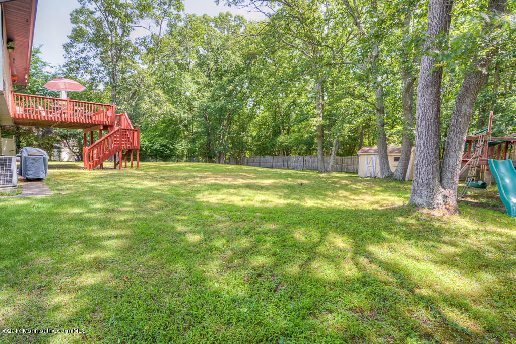 116 Newbury Road Howell, NJ 07731 - Photo 19 of 19 a view of backyard with swimming pool and seating space