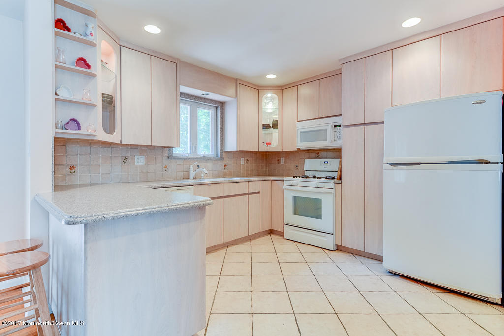 116 Newbury Road Howell, NJ 07731 - Photo 5 of 19 a kitchen with white cabinets and white appliances