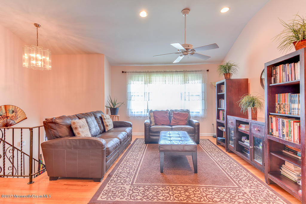 116 Newbury Road Howell, NJ 07731 - Photo 6 of 19 a living room with furniture a window and bookshelf