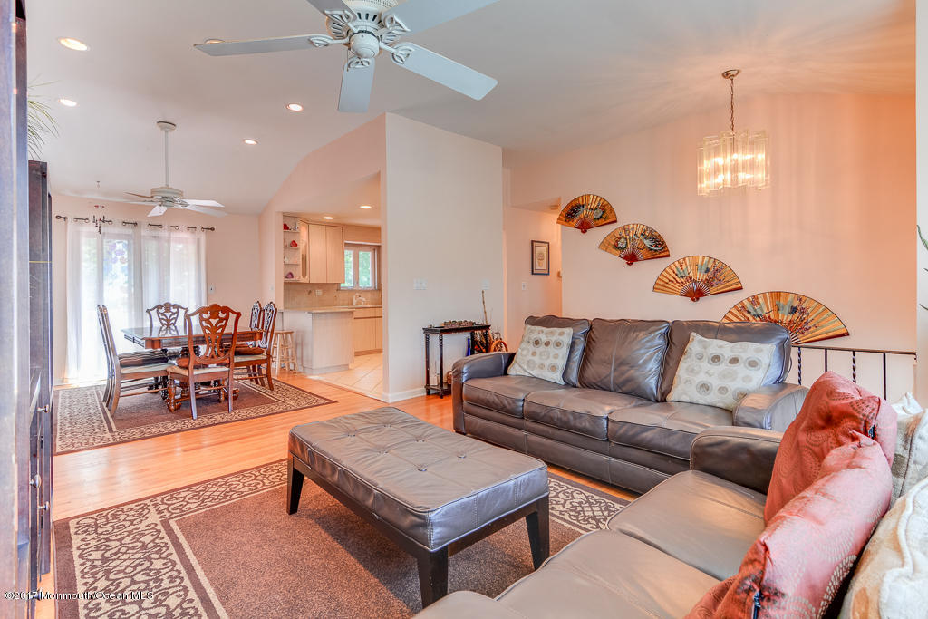 116 Newbury Road Howell, NJ 07731 - Photo 8 of 19 a living room with furniture and a chandelier