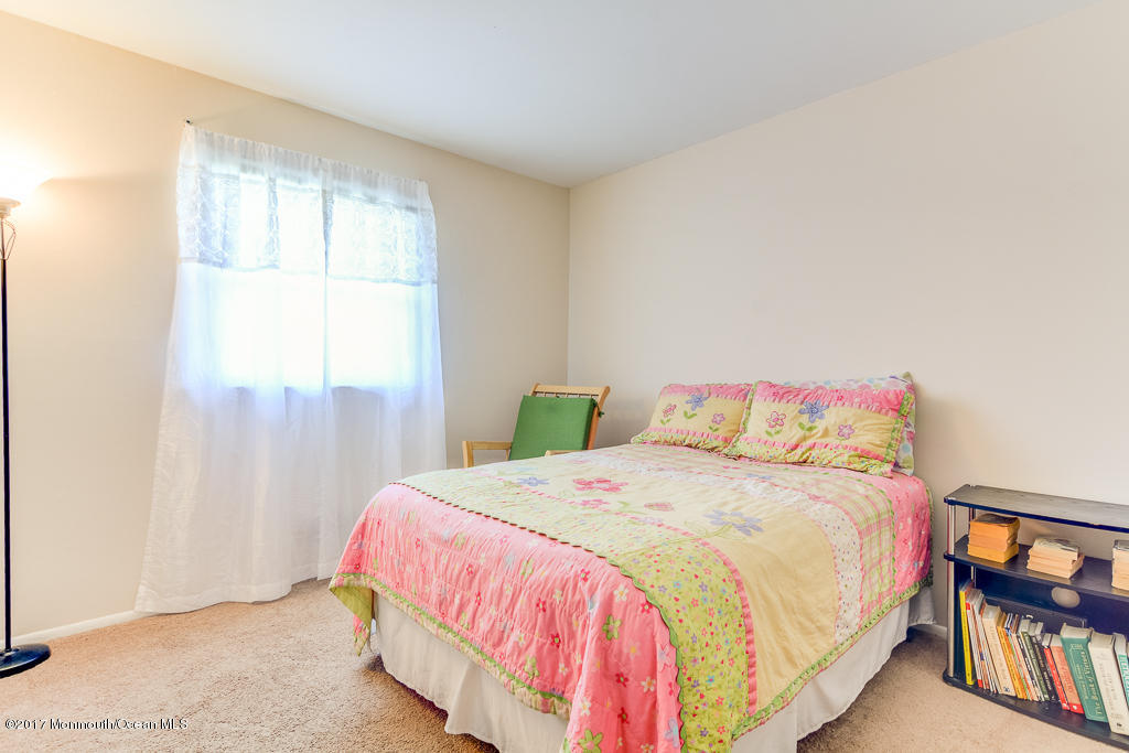 116 Newbury Road Howell, NJ 07731 - Photo 10 of 19 a bedroom with a bed and a painting on the wall