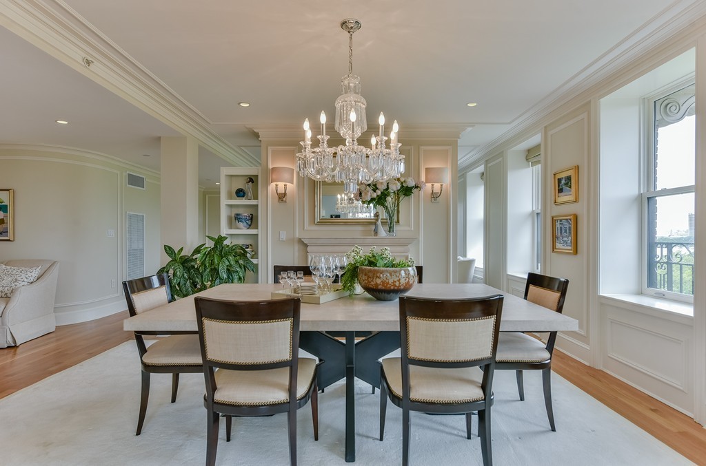 a view of a dining room with furniture and chandelier