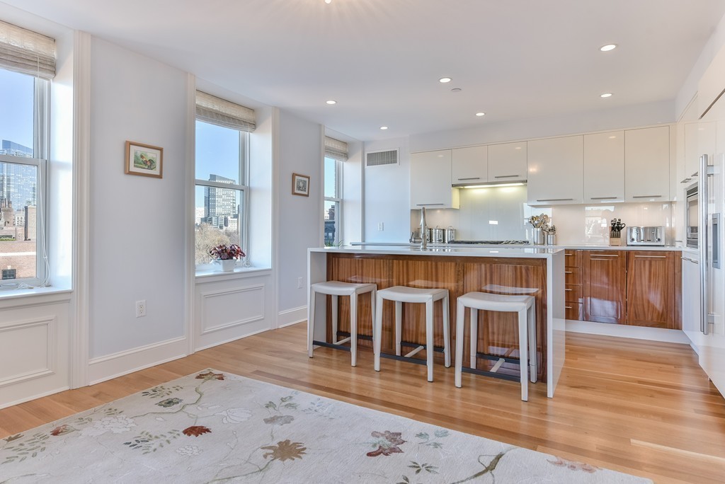 100 Beacon Street, Unit 7 Boston, MA 02116 - Photo 7 of 17 a dining hall with stainless steel appliances granite countertop a stove top oven a dining table and chairs with wooden floor