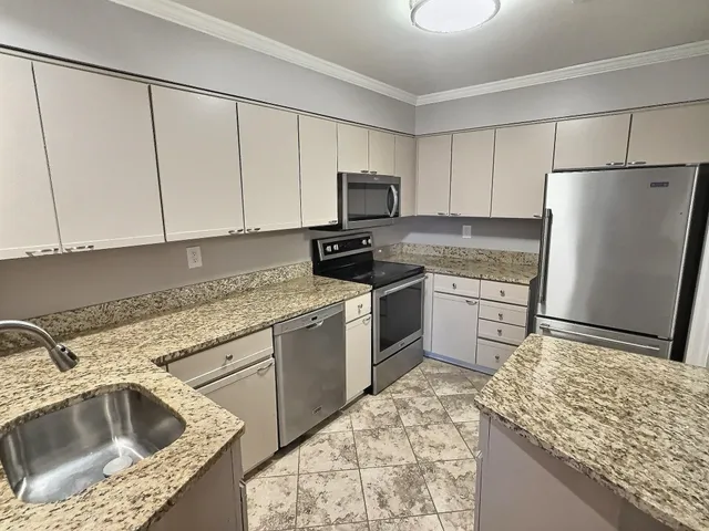 a kitchen with a sink stove and refrigerator