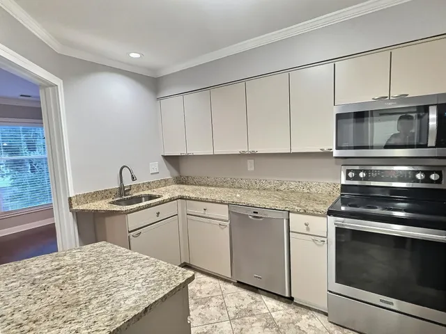 a kitchen with a stove and a sink