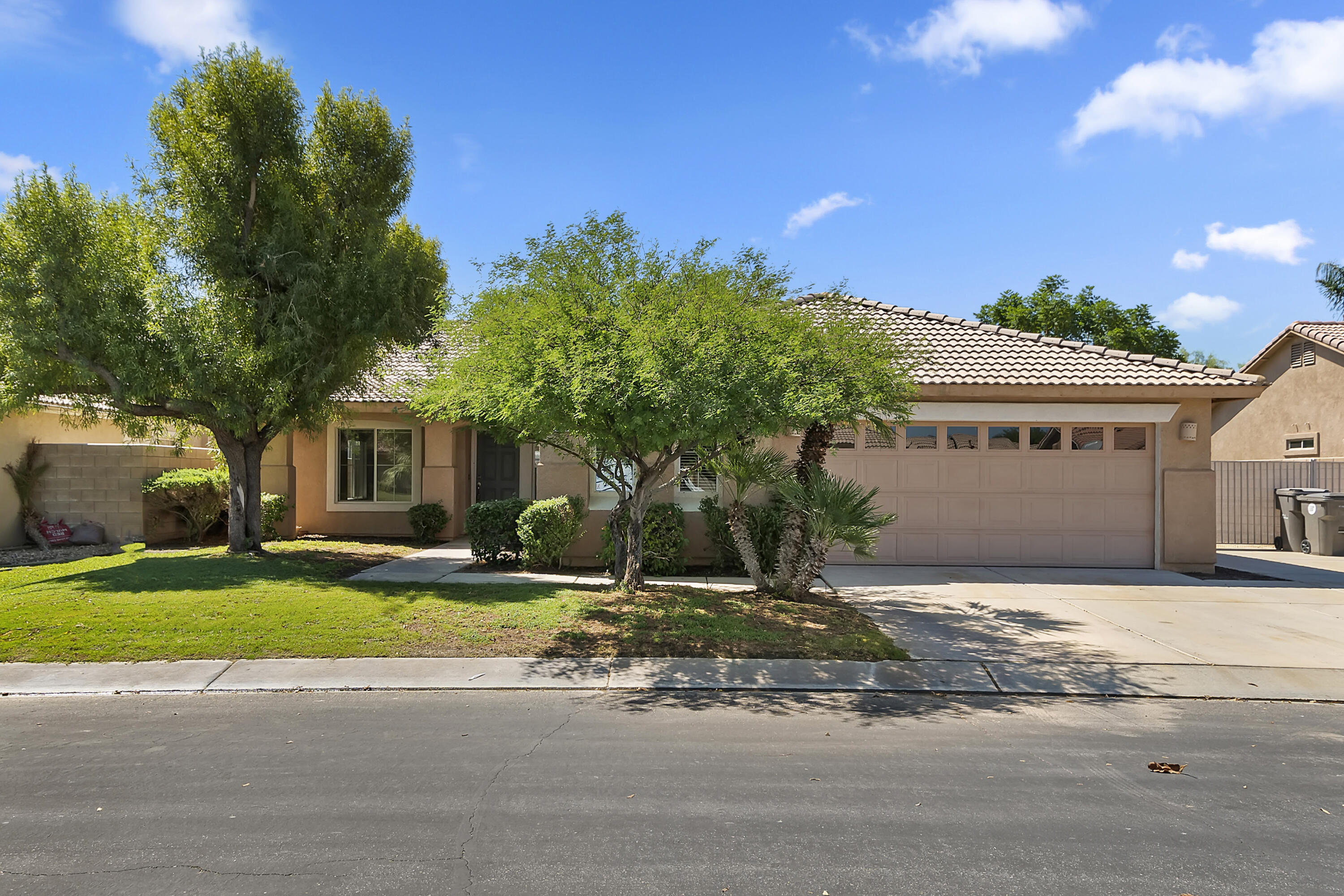 80669 Freedom Avenue Indio, CA 92201 - Photo 13 of 30 a front view of a house with a yard and garage