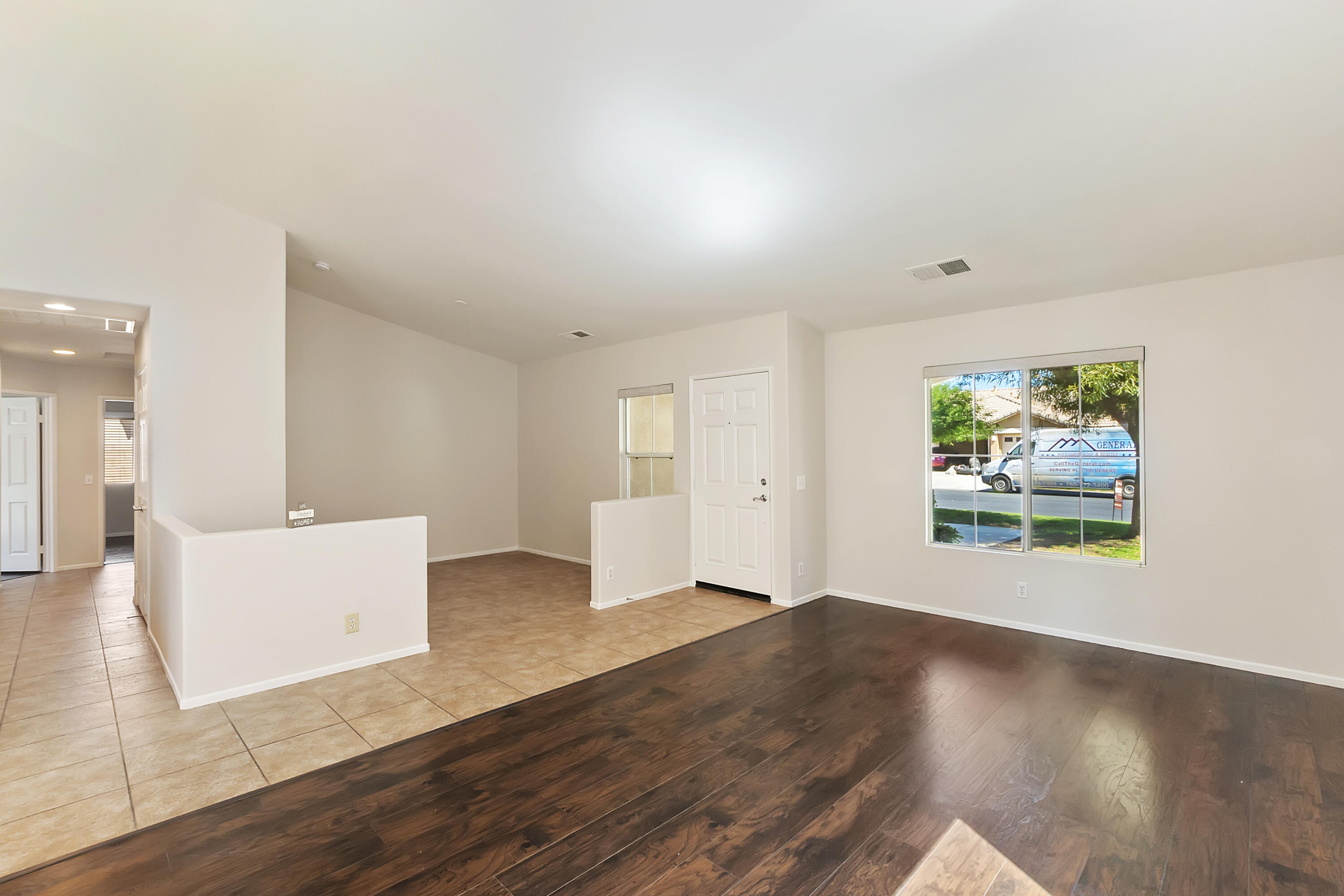 80669 Freedom Avenue Indio, CA 92201 - Photo 2 of 30 an empty room with wooden floor and windows