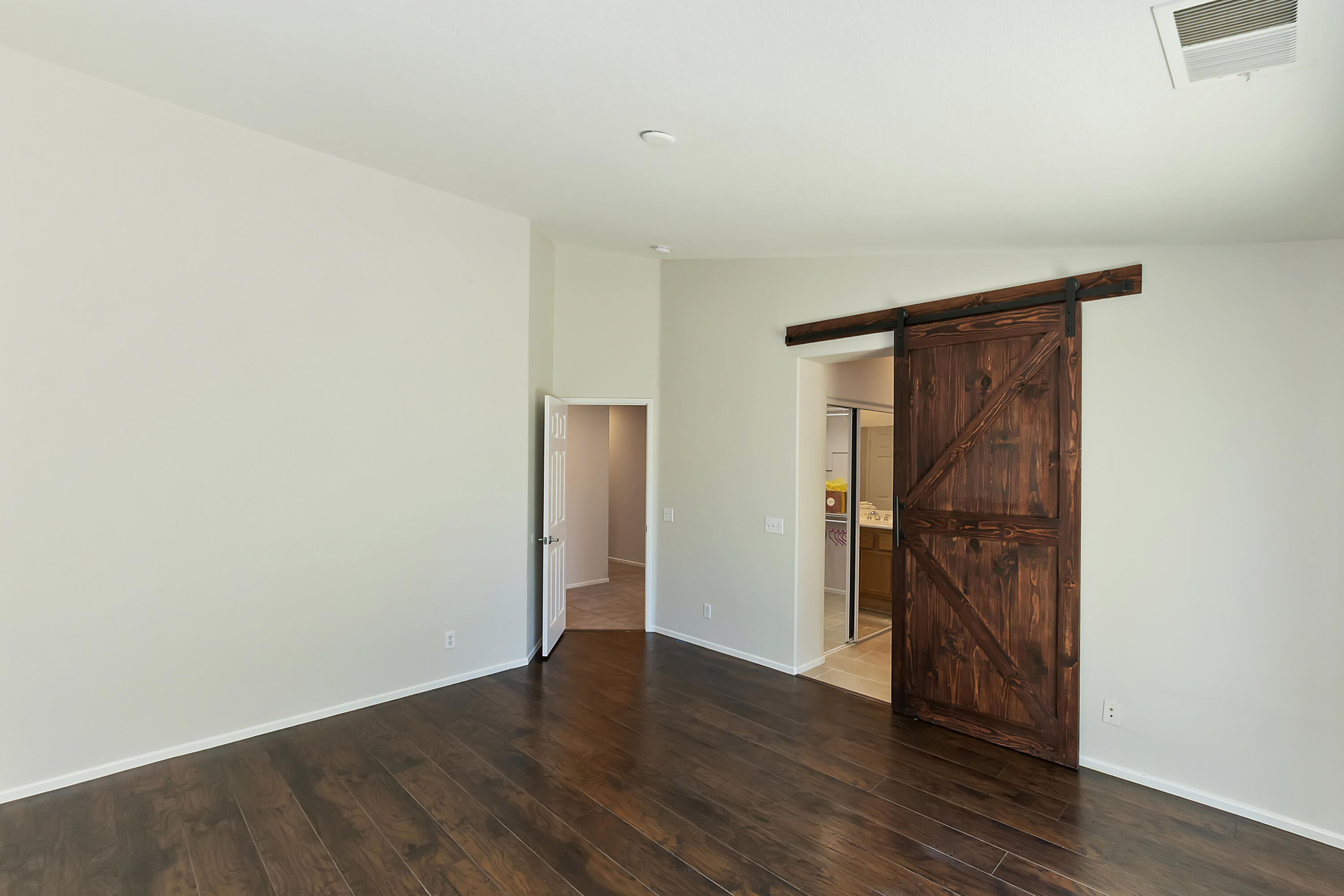 80669 Freedom Avenue Indio, CA 92201 - Photo 22 of 30 a view of an empty room with wooden floor and closet