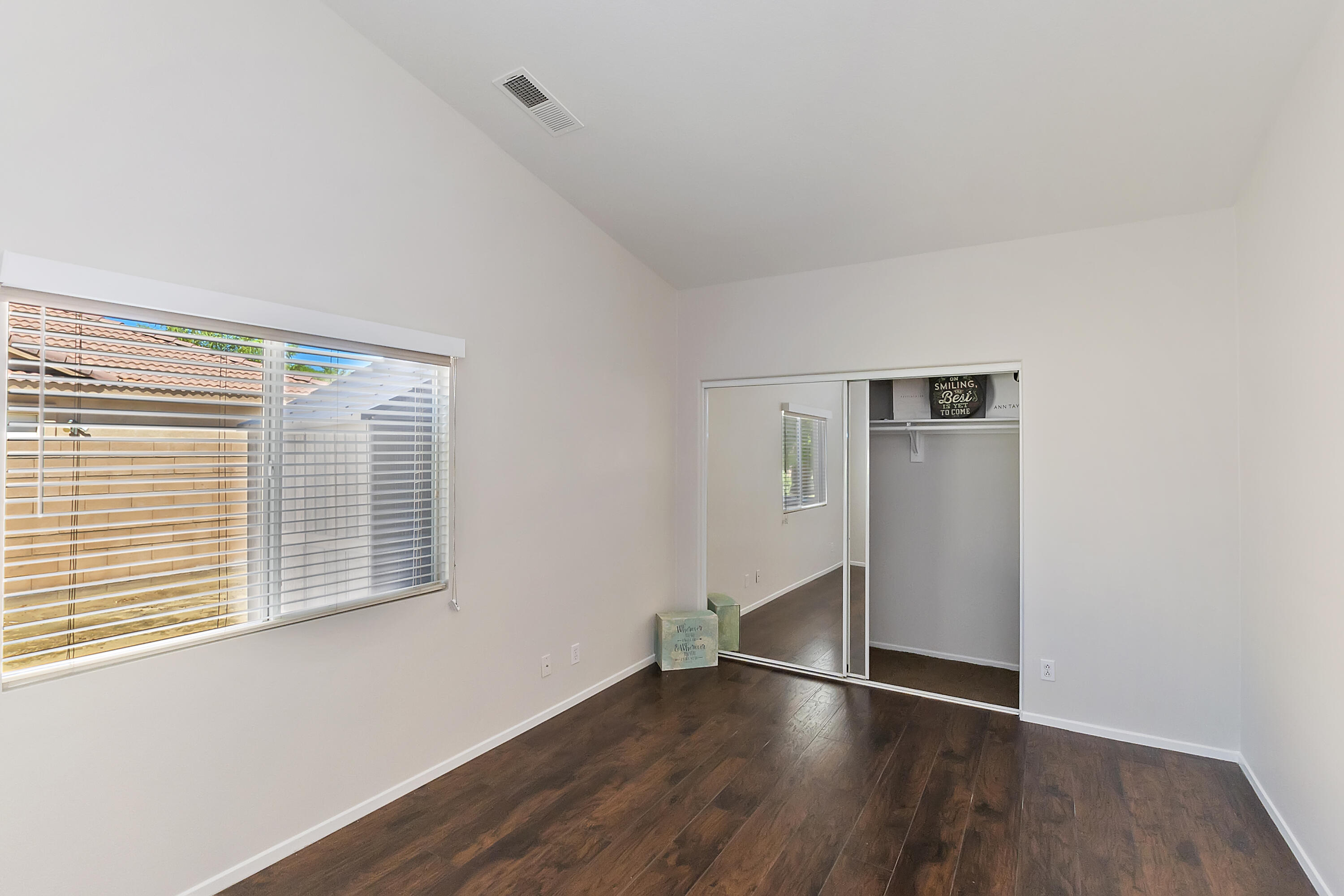 80669 Freedom Avenue Indio, CA 92201 - Photo 24 of 30 an empty room with wooden floor and windows