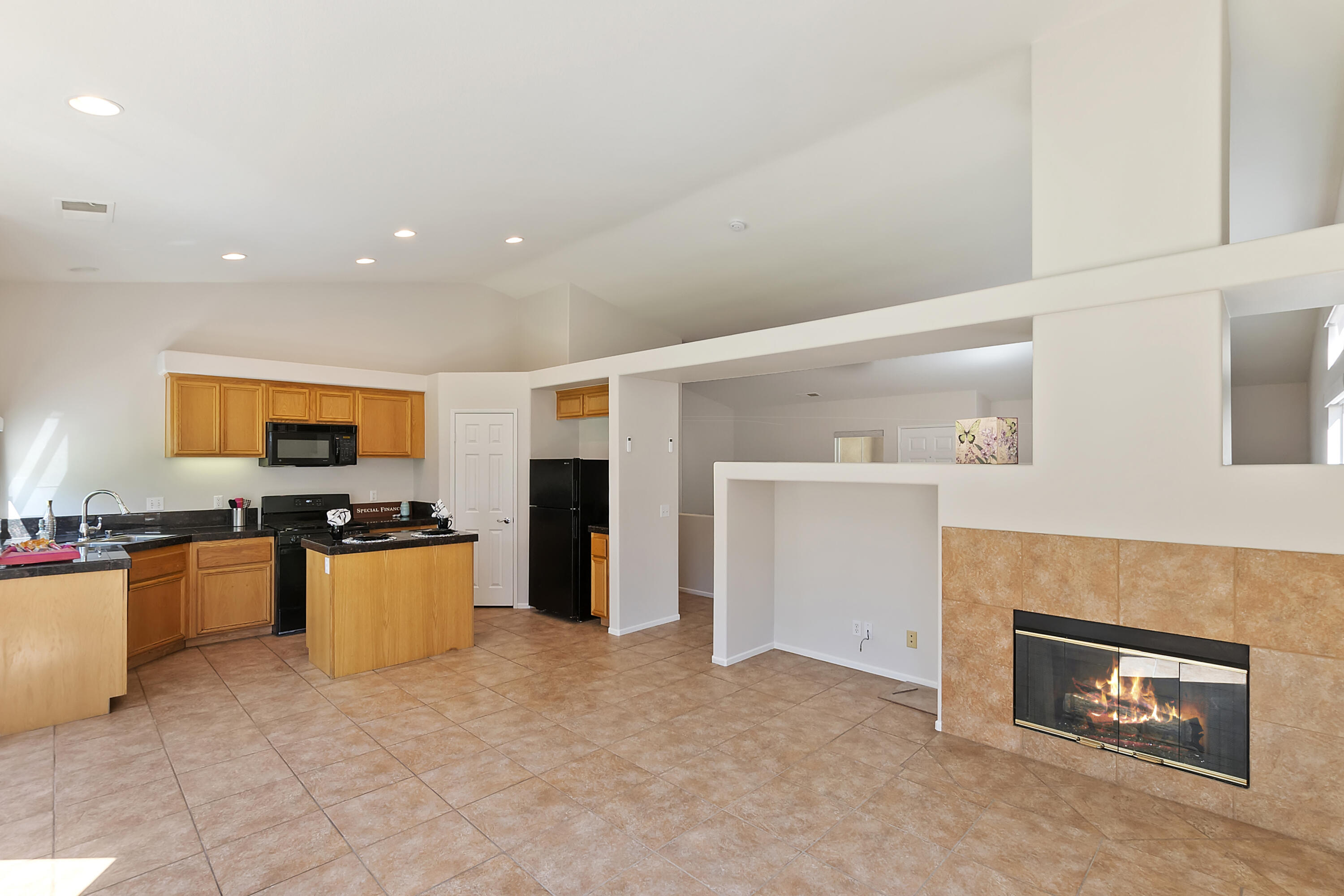80669 Freedom Avenue Indio, CA 92201 - Photo 3 of 30 a large kitchen with stainless steel appliances granite countertop a stove top oven a sink and a refrigerator