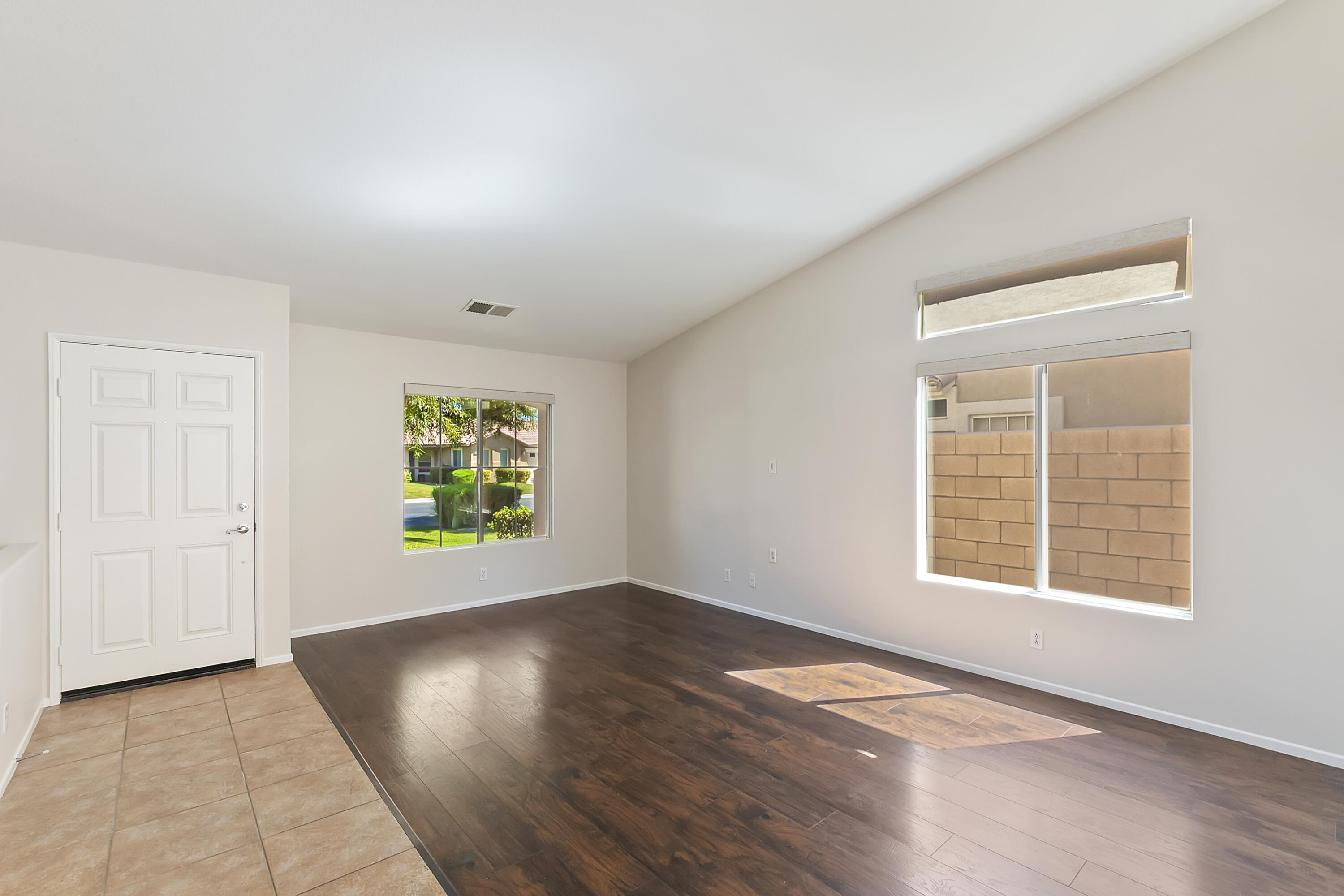 80669 Freedom Avenue Indio, CA 92201 - Photo 9 of 30 an empty room with wooden floor cabinet and windows