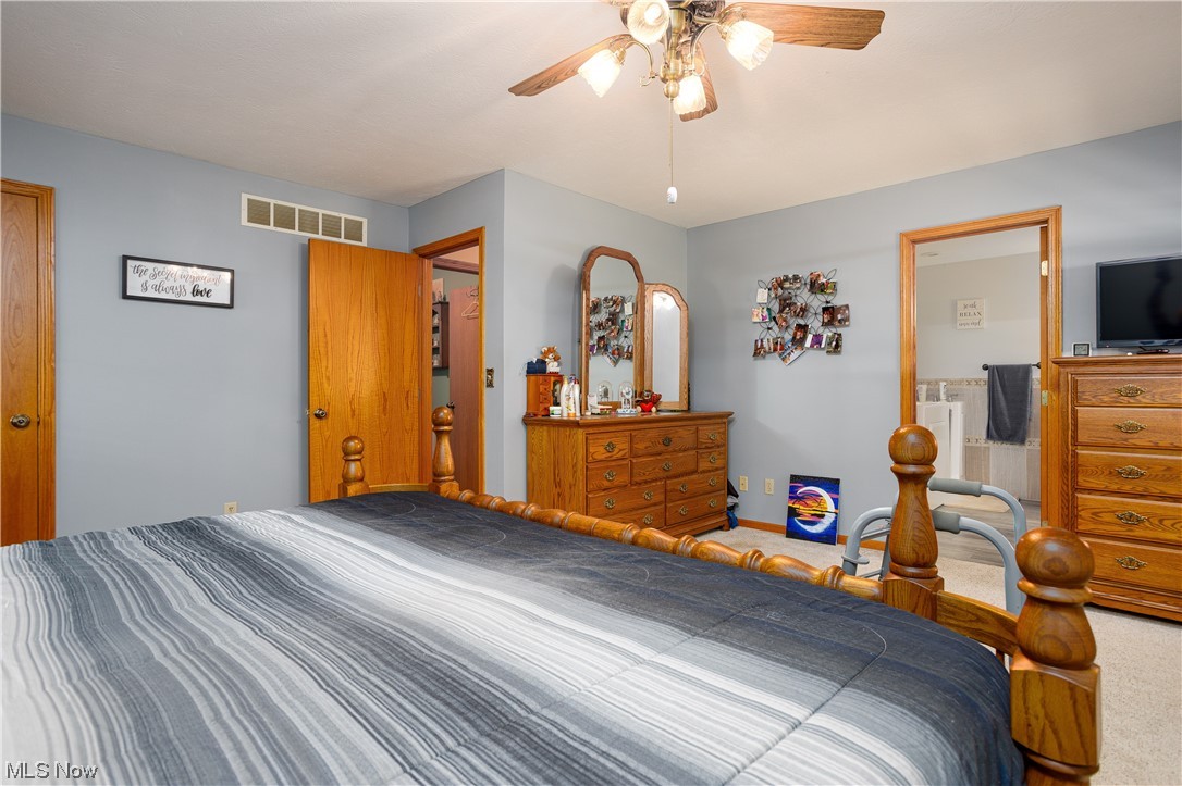 9929 Finley Road Wooster, OH 44691 - Photo 21 of 33 Carpeted master bedroom featuring ceiling fan