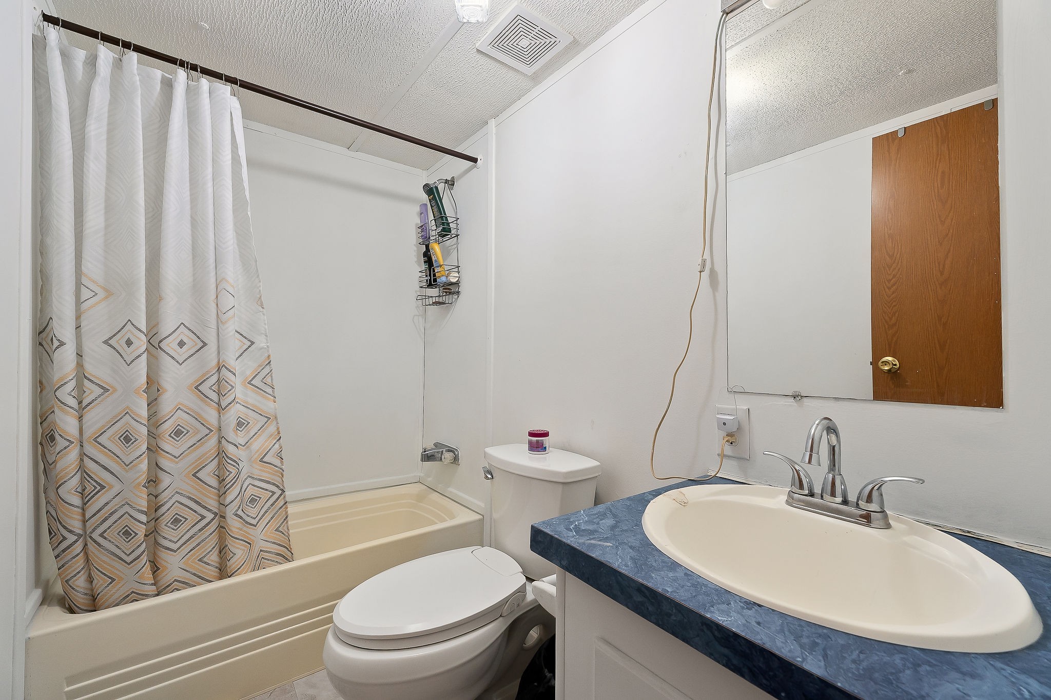 280 Bone Cave Road Rock Island, TN 38581 - Photo 12 of 27 a bathroom with a sink a toilet and shower curtain
