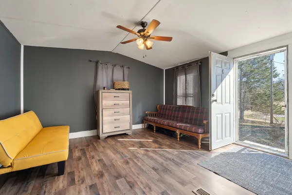 a view of a livingroom with furniture and a ceiling fan