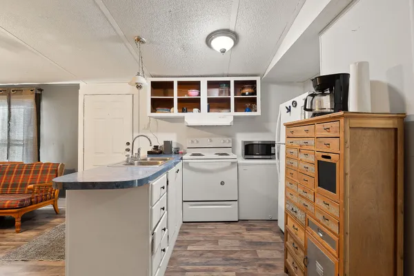 a kitchen with a cabinets and wooden floor