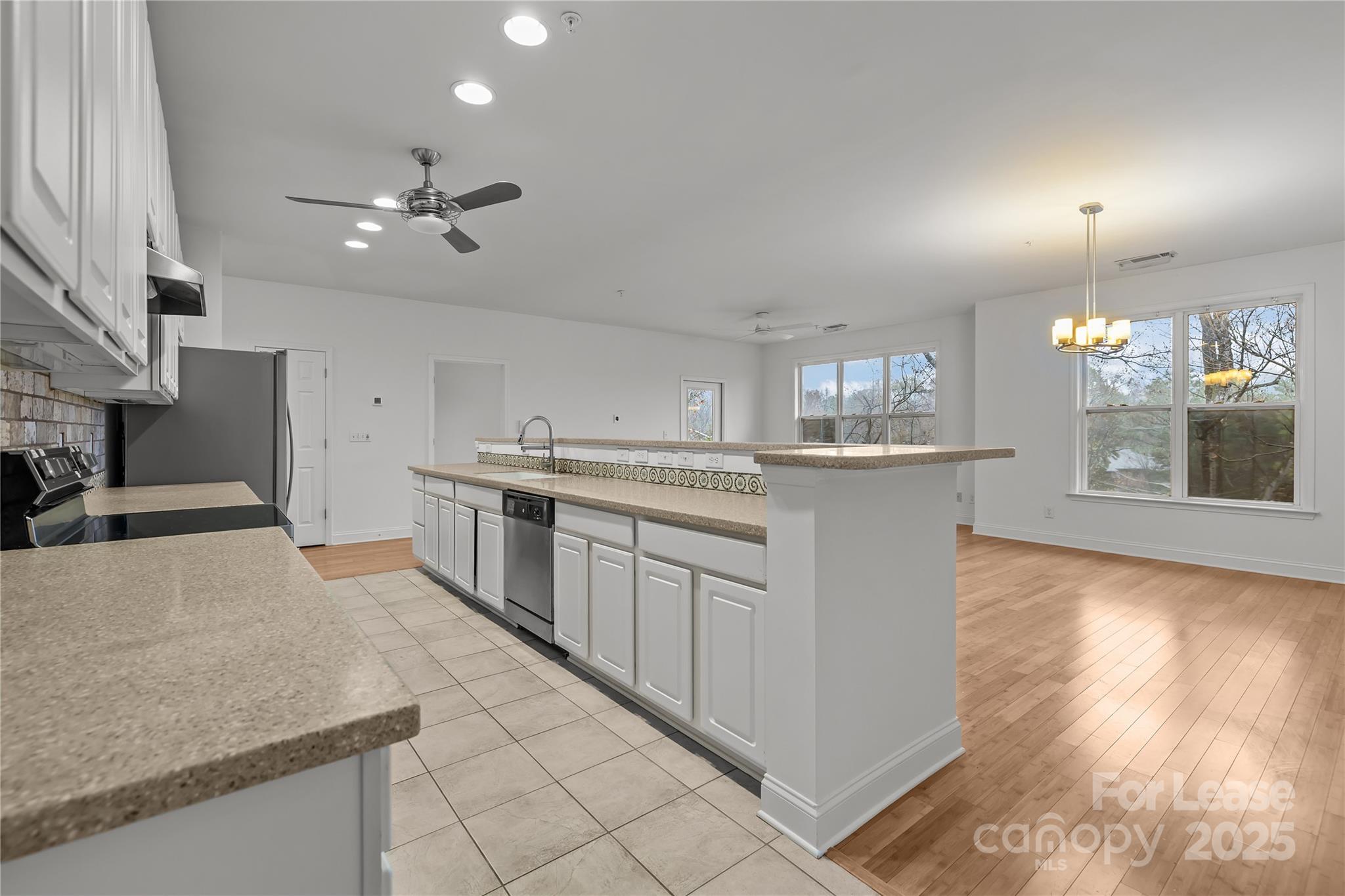 1000 East Woodlawn Road, Unit 416 Charlotte, NC 28209 - Photo 13 of 32 a kitchen with stainless steel appliances granite countertop a sink and stove
