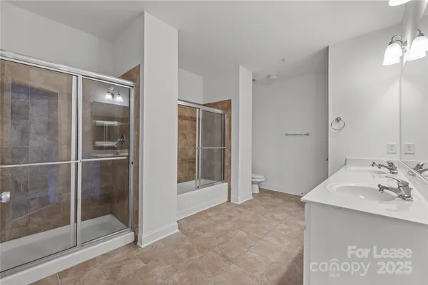 a bathroom with a shower sink and mirror