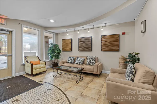 a living room with furniture and a potted plant