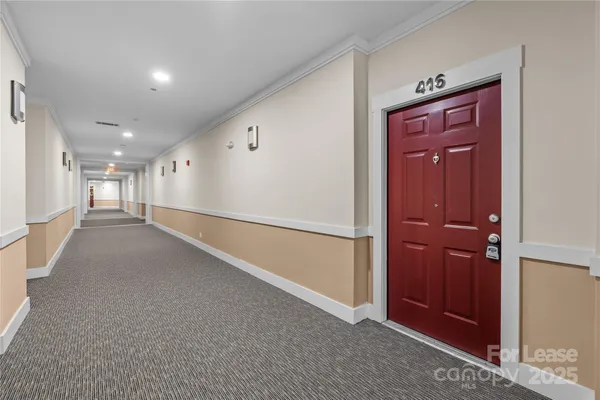 an empty room with closet and windows