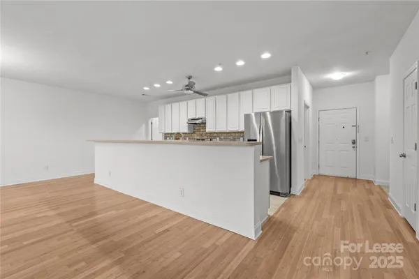 a kitchen with stainless steel appliances granite countertop a refrigerator sink and cabinets