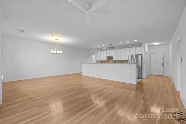 a kitchen with stainless steel appliances granite countertop a sink a oven and a refrigerator