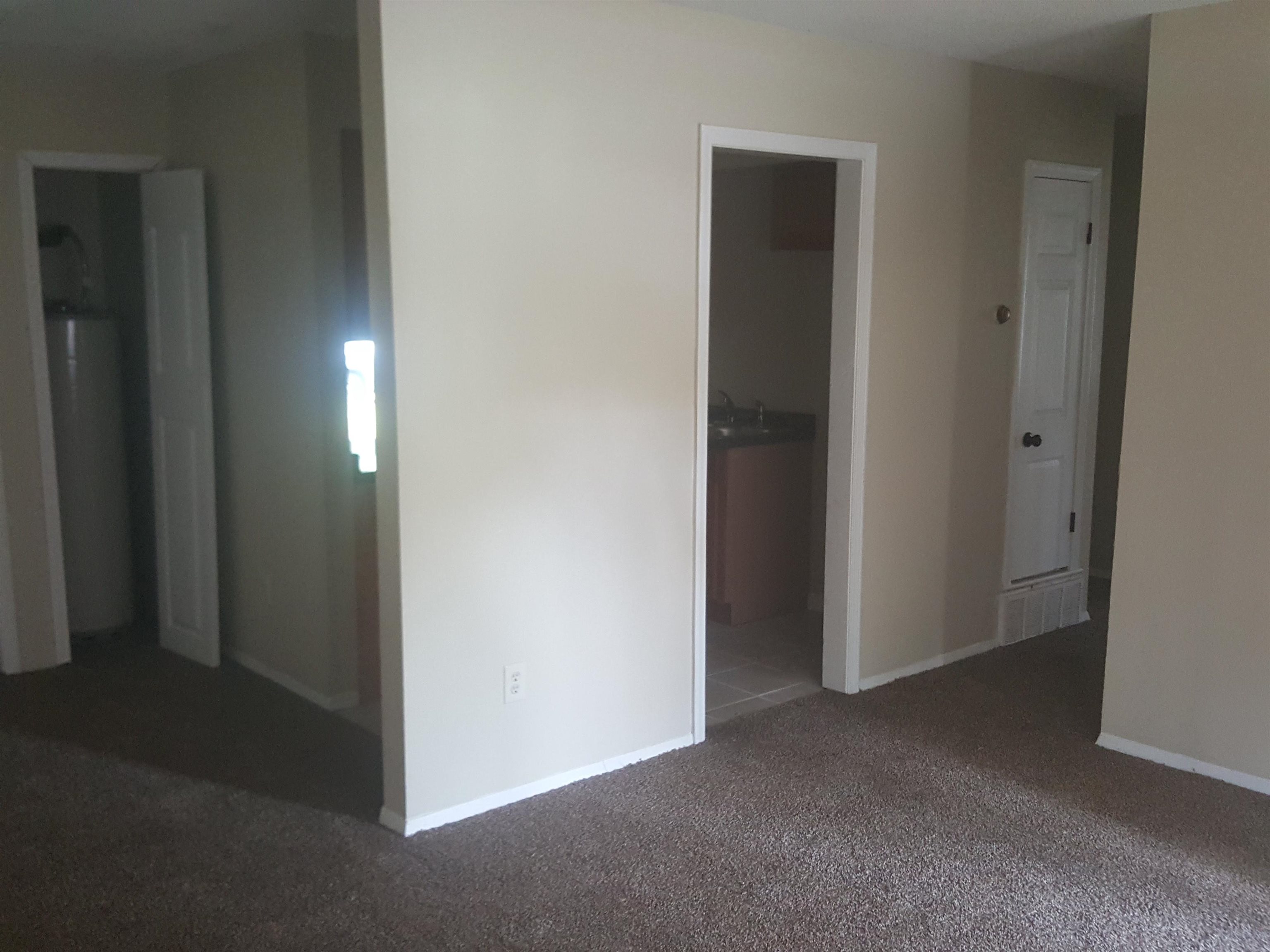3667 Windermere Road Memphis, TN 38128 - Photo 2 of 8 Interior space featuring baseboards, water heater, carpet floors, and a sink