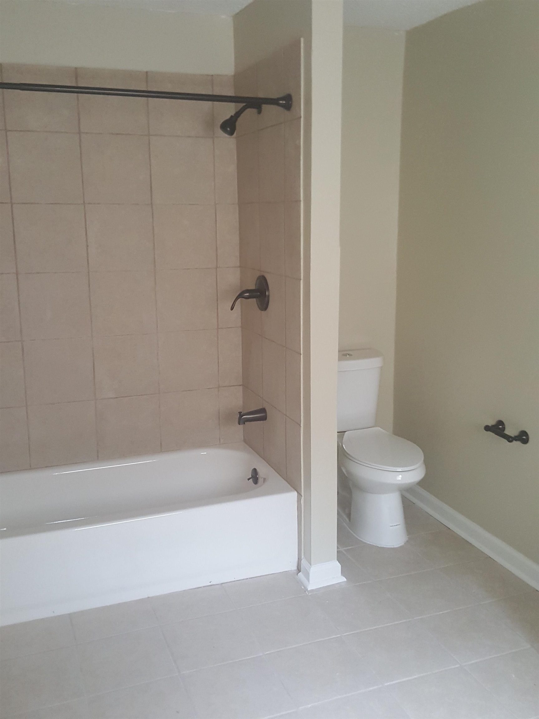 3667 Windermere Road Memphis, TN 38128 - Photo 5 of 8 Bathroom featuring baseboards, toilet, shower / bathtub combination, and tile patterned flooring