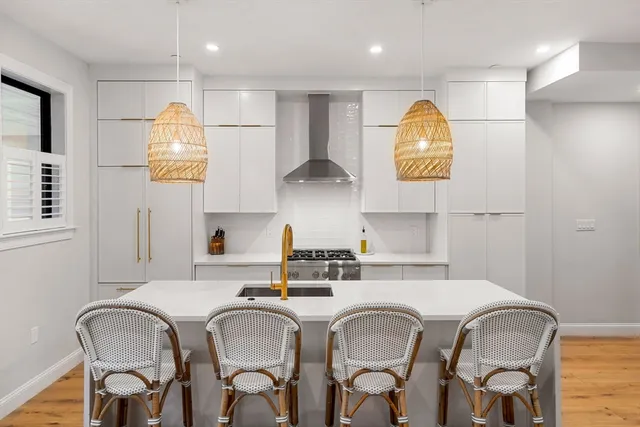 a kitchen with stainless steel appliances granite countertop a sink and a refrigerator