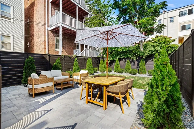 a view of backyard of house with seating space