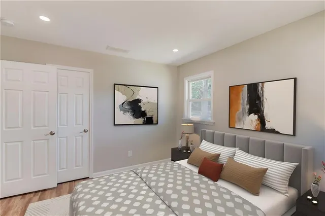 a bedroom with a large bed and a painting on the wall