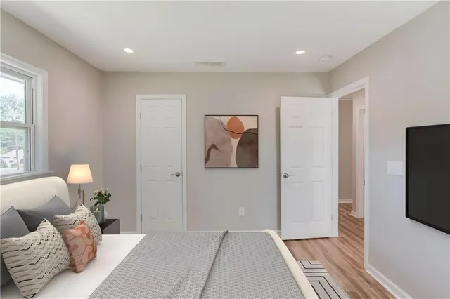 a bedroom with furniture and a flat screen tv