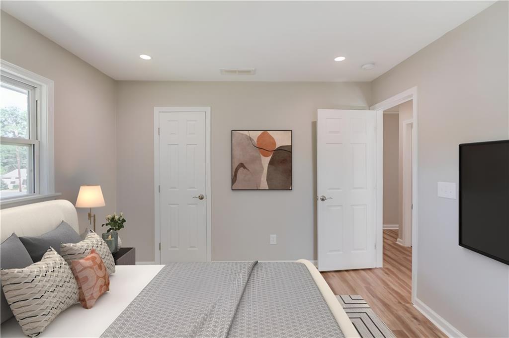 4483 Florence Street Tucker, GA 30084 - Photo 14 of 18 a bedroom with furniture and a flat screen tv