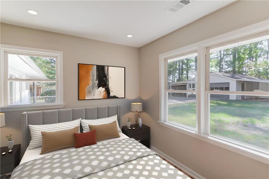 4483 Florence Street Tucker, GA 30084 - Photo 16 of 18 a bedroom with a large bed and a window