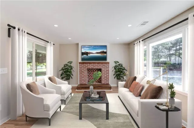 a living room with furniture fireplace and a large window