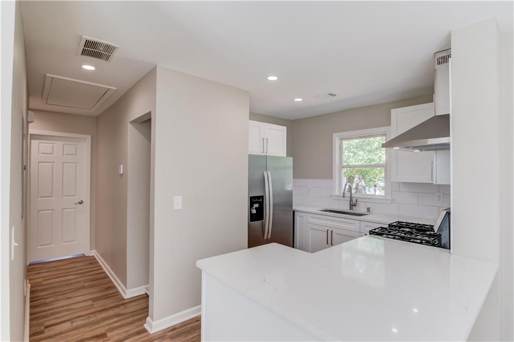 4483 Florence Street Tucker, GA 30084 - Photo 9 of 18 a kitchen with a refrigerator a sink and wooden floor