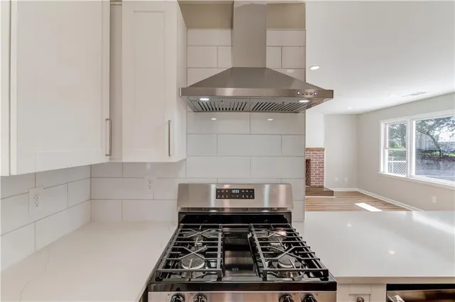 a stove top oven sitting inside of a kitchen