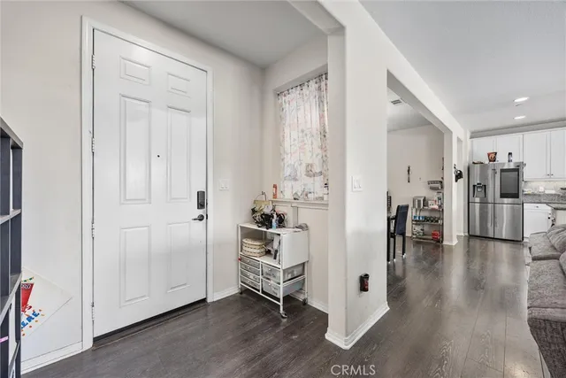 a view of a kitchen with wooden floor and electronic appliances