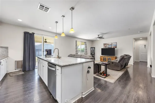 a open kitchen with stainless steel appliances granite countertop a stove and a wooden floors